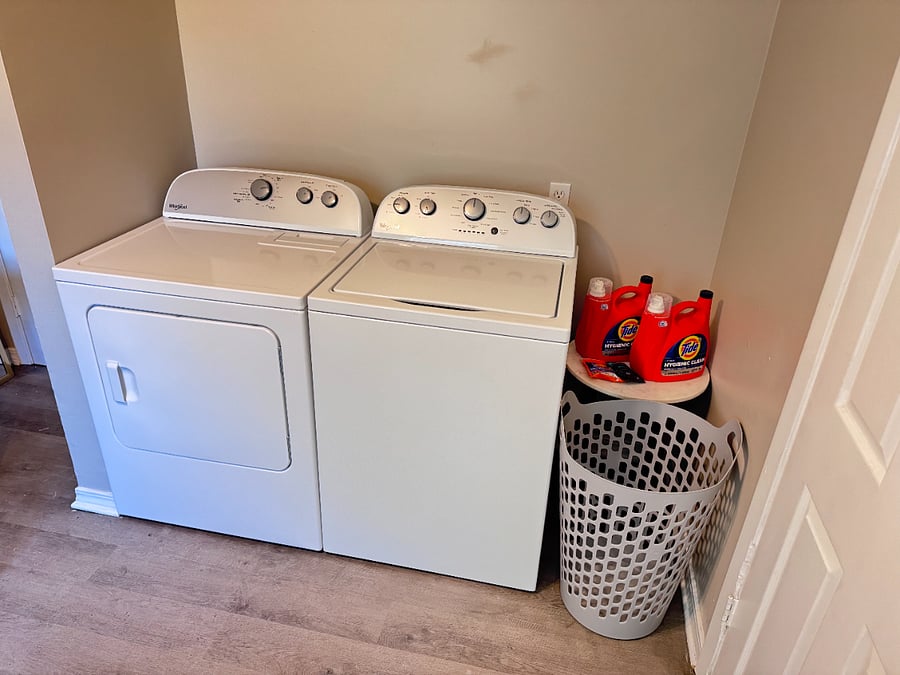 Washer and Dryer with fully stocked supplies.