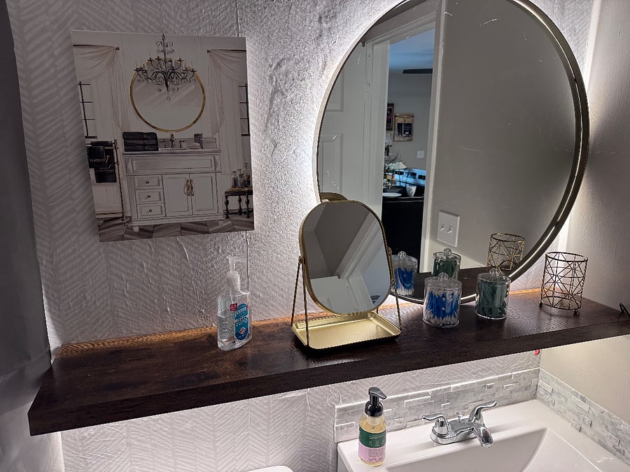 Bathroom features ambient lighting.