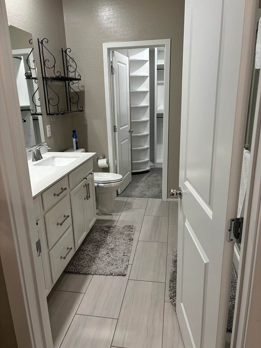 Master bath with dual sinks and walk-in closet 