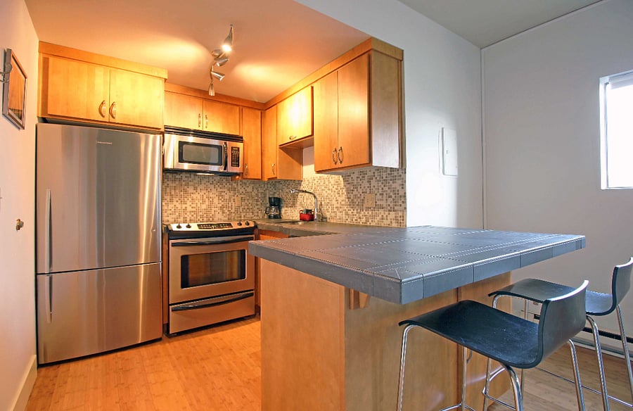 Spacious kitchen with eating bar.
