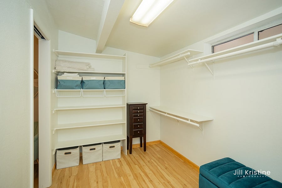 Huge primary walk-in closet with hangers, seating bench, jewelry box and will add hotel room safe per request.  