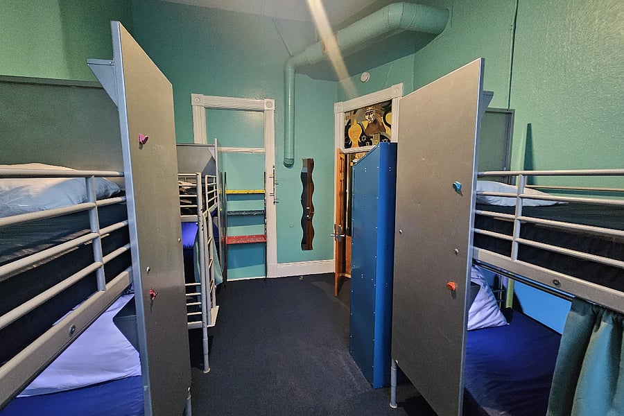 Six bed dorms facing the street have 10 foot tall windows. Those toward the back have smaller windows but are quieter. We also have private rooms for rent.