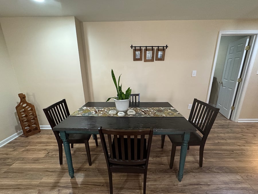 Living room and dining area (view 5), 4-person dining table; door to right leads to bedroom #1
