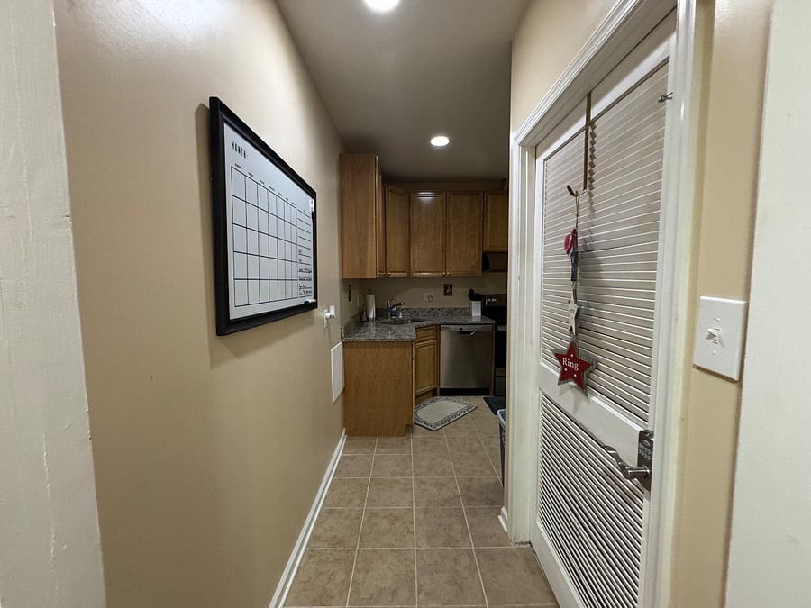 Entryway to kitchen (door to right is keypad secured and leads to whole-house utilities room); Kitchen is fully furnished with essentials and starter items