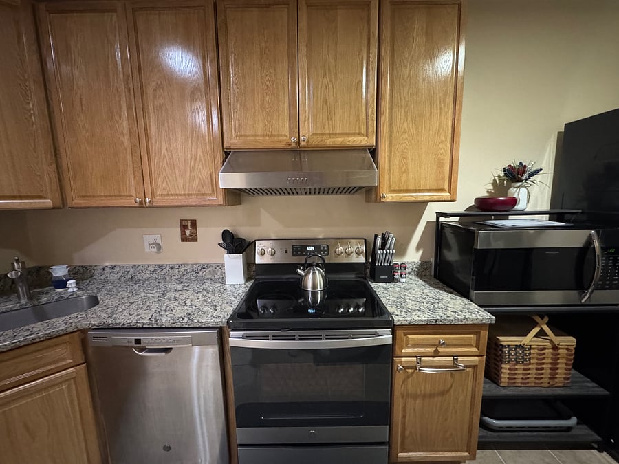 Kitchen (view 2); dishwasher, stove, external vented exhaust fan with light, large microwave, cooking utensils