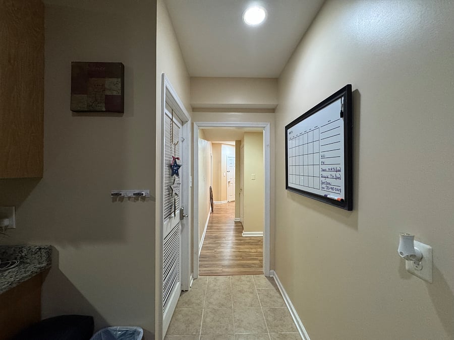 Kitchen (view 5); leaving kitchen toward hallways (right toward living room/bath/bedroom #1 or straight/left to foyer/bedroom #2); Note: Kitchen whiteboard will contain property information (e.g., entryway code, WIFI, trash schedule, etc.)