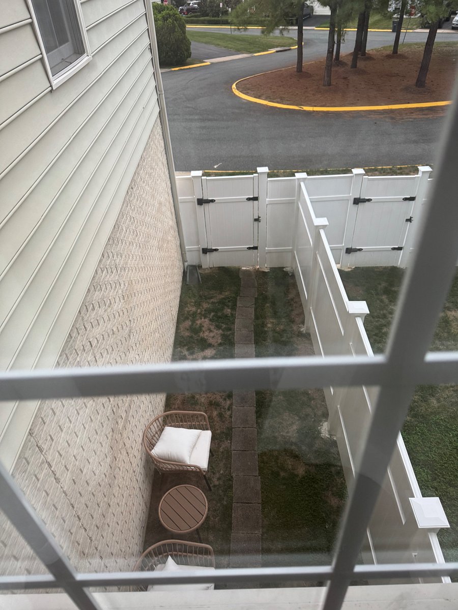 Update: Sep 2025. View from above of new privacy fence area (tenants private use and private entry on left side with small table and two chairs)