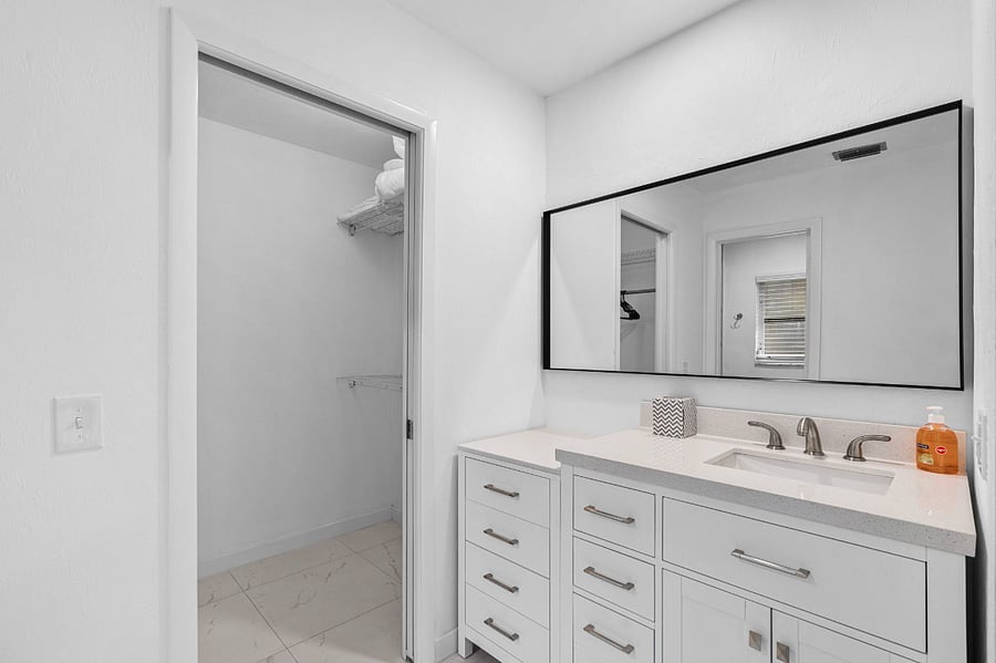1st master bedroom with vanity and walk in closet