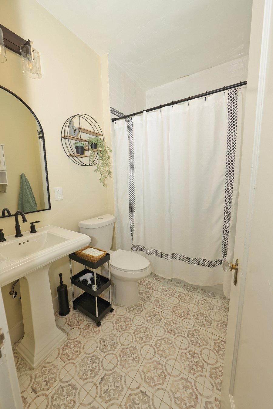 Main bathroom- 3 piece with tub, extra storage cabinet, and hair dryer.