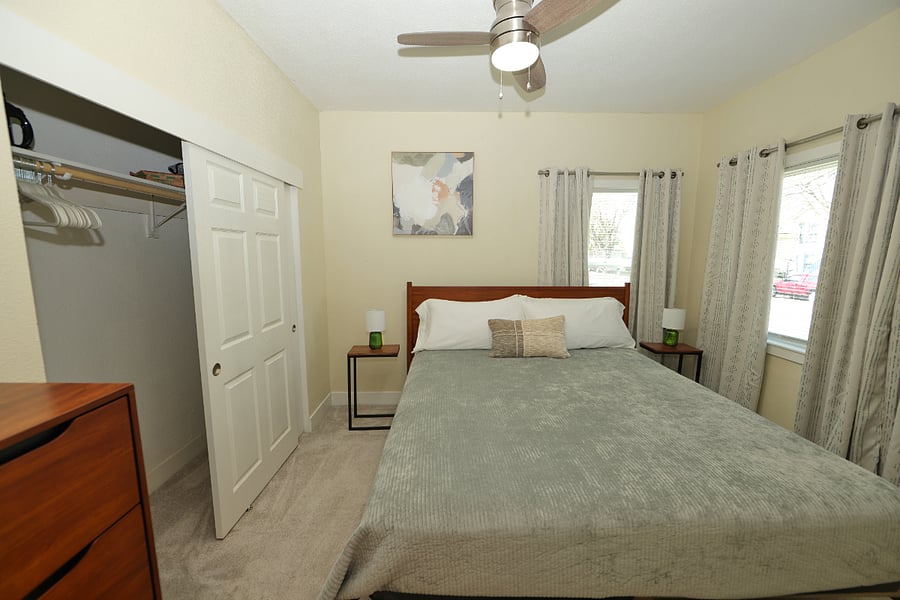 Primary Bedroom with Cal King bed, 55" flat screen, blackout curtains  and ensuite bathroom.