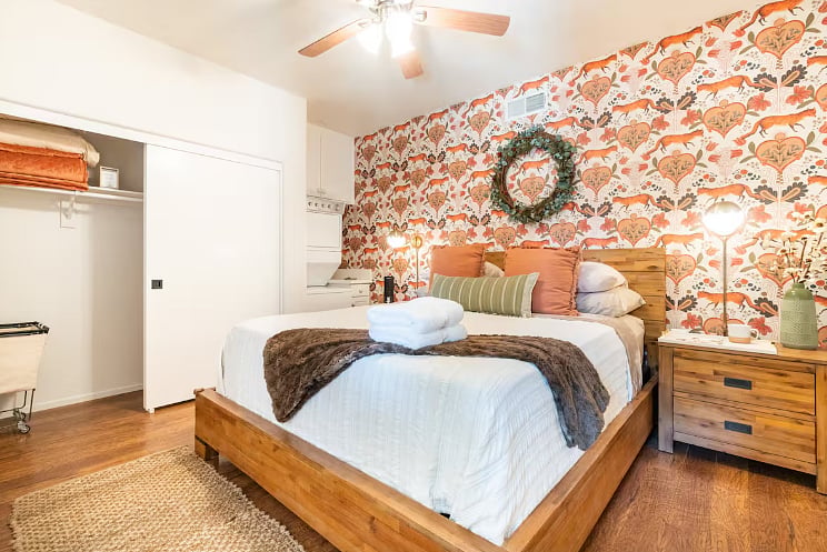 Large custom cal king bedroom and super soft bedding for a great nights rest. Also custom designed wallpaper to create a unique space for our guests to enjoy