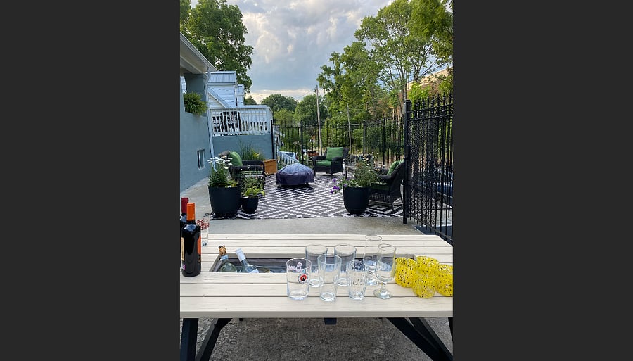 Plenty of deck space with a grill, picnic table, chairs and planters