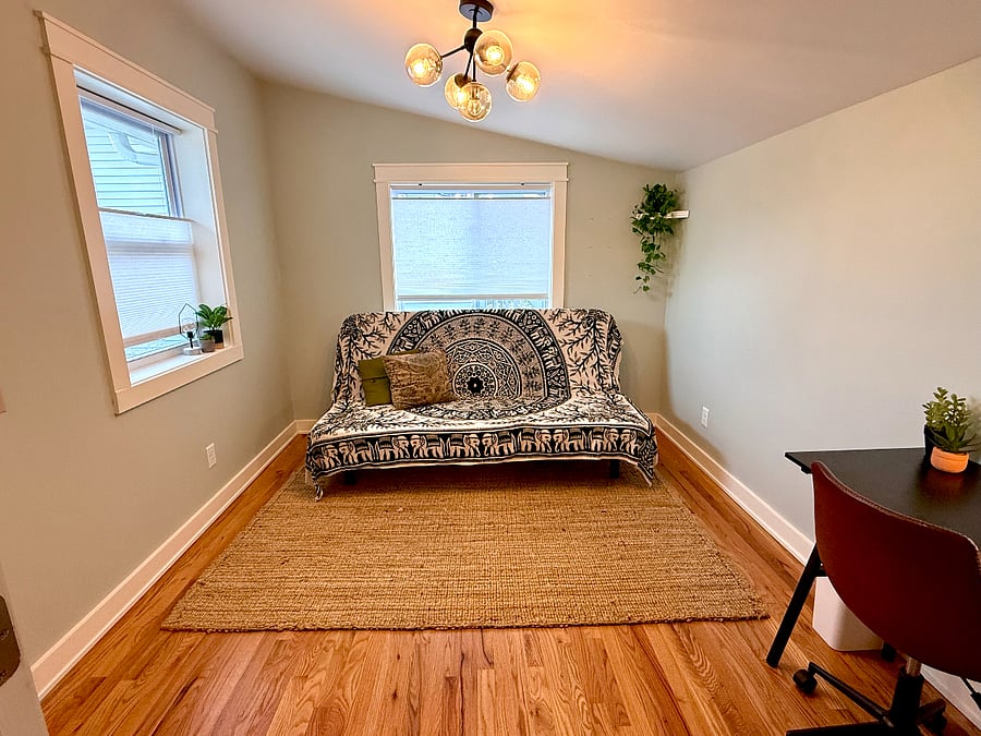 Guest room / office with desk, futon, and closet