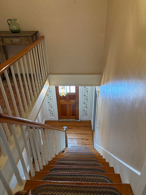Stairs to 2nd floor where the 3 bedrooms, full bath and washer/dryer