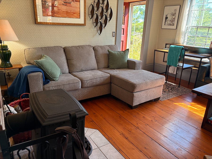 Living room with TV, desk and wood stove