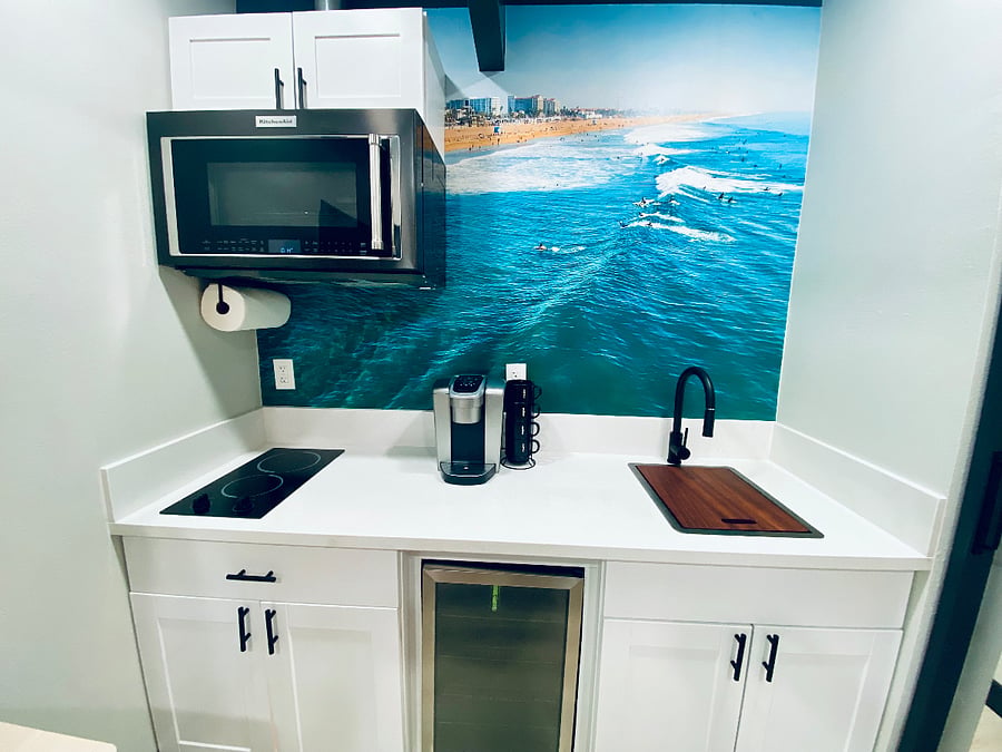 Kitchenette with stainless steel sink, beverage frig, 2 top electric cooktop, stone countertop