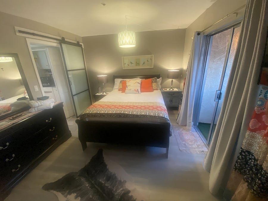 Main bedroom with barn door that is frosted for extra privacy.