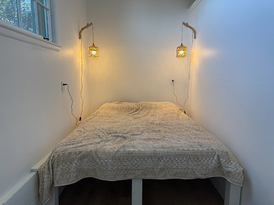 Bedroom nook feels separate from the living and cooking areas.