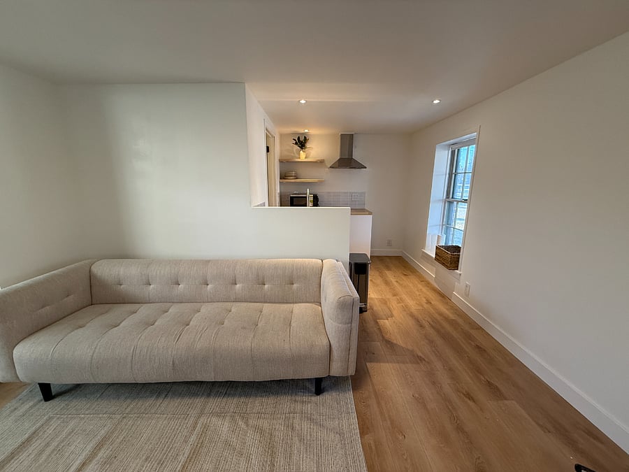 Comfortable 80 inch couch in living area.
