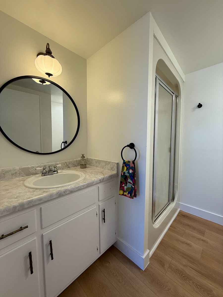Bathroom with step in shower and ample storage.
