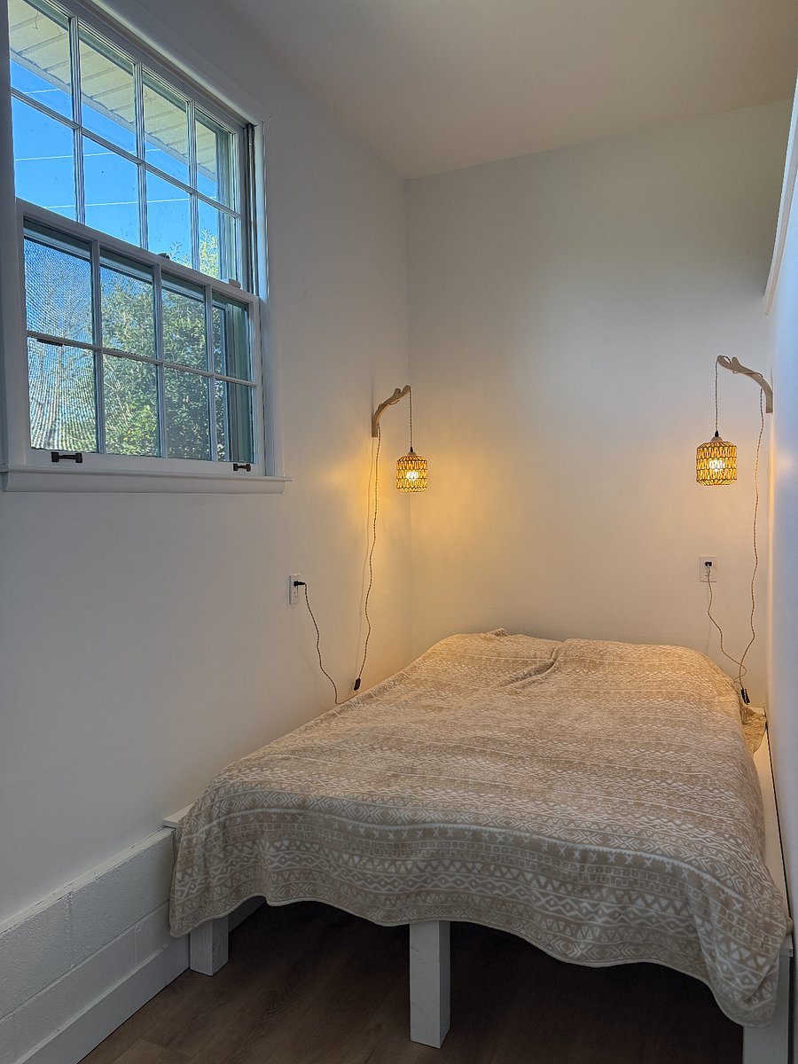 Comfortable queen sized bed with blackout curtains.
