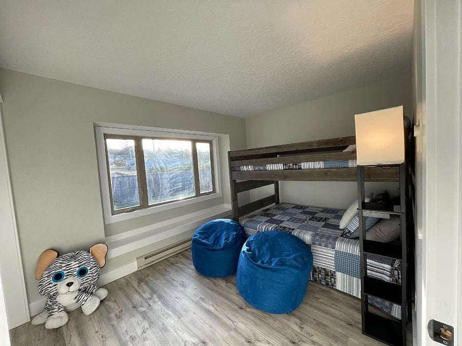 Bedroom #3: Features full-sized bunk beds and twin sized trundle bed. Third bathroom with tub, shower, toilet and sink, located directly across from bedroom #3 (photo taken from bedroom entry, with bean bags included).