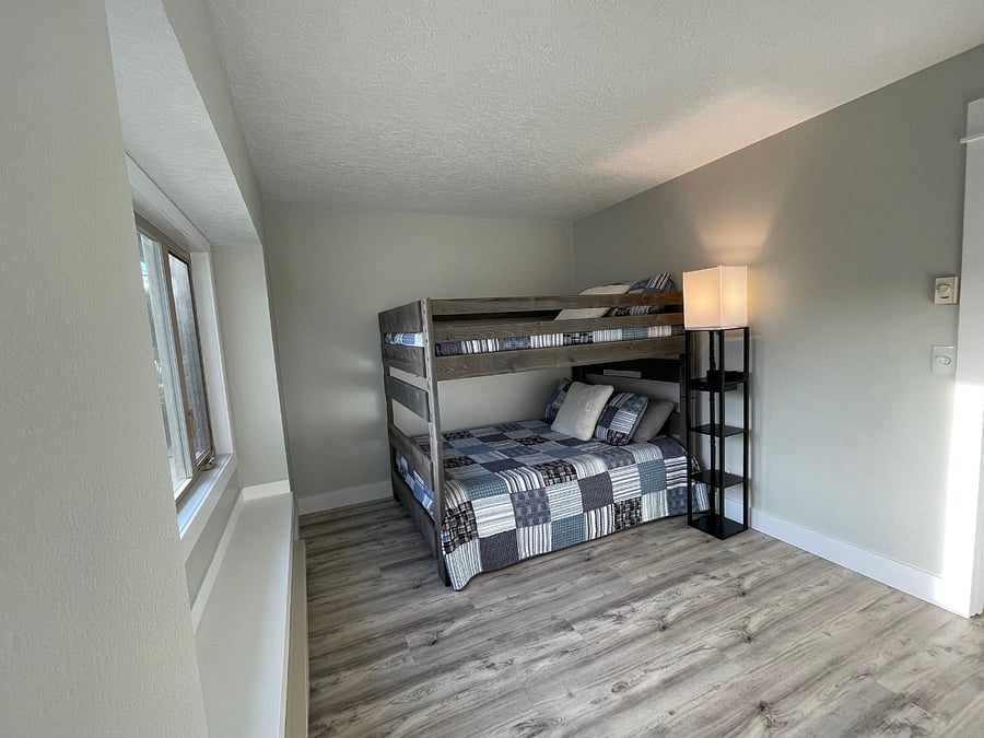 Bedroom #3: Features full-sized bunk beds and twin sized trundle bed and Roku TV. Third bathroom with tub, shower, toilet and sink, located directly across from bedroom #3 (photo taken from bedroom closet).