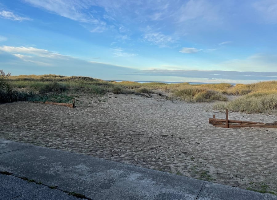 Sandy backyard, excellent for outdoor play. Patio runs the full length of the house offering plenty of outdoor entertainment space.