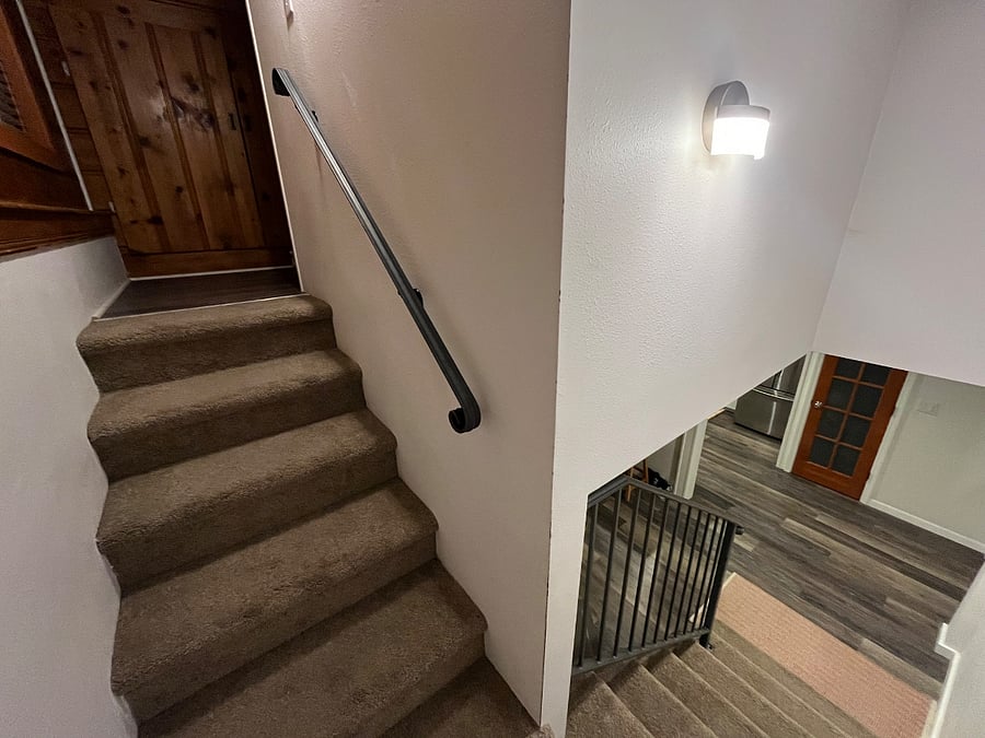 stairs to master bedroom and door to private bathroom downstairs