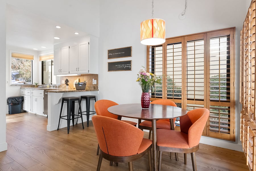 A stylish yet inviting dining room, filled with natural light and offering picturesque courtyard views.