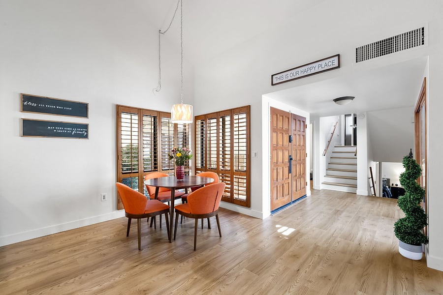 A cozy yet modern dining room with abundant natural light and charming courtyard views.