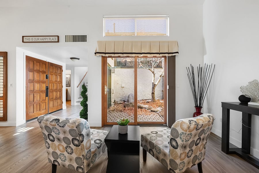 A cozy sitting area overlooking the atrium, bathed in natural light and offering a serene retreat to relax, read, or enjoy the peaceful views.