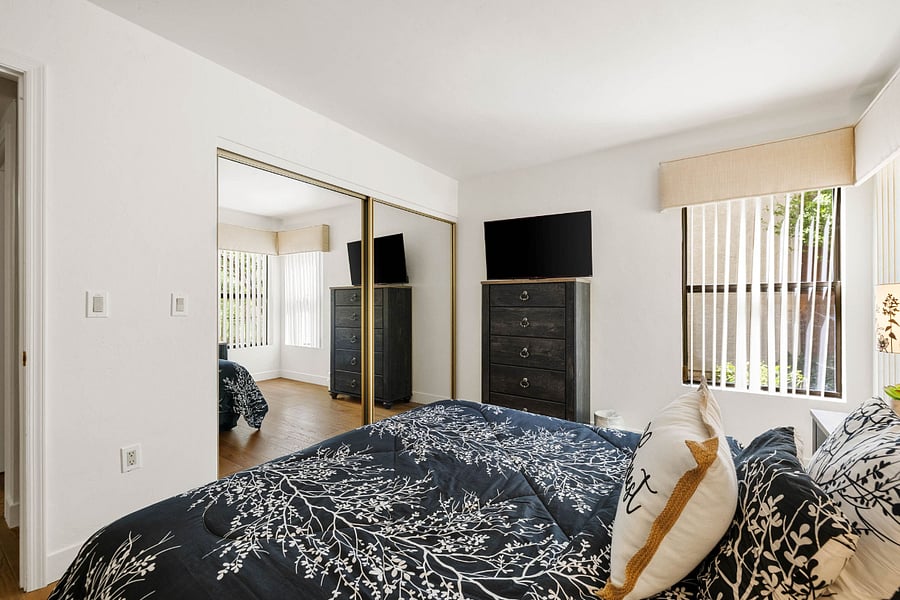 Bedroom 2:
Ground-level queen bedroom offering added privacy, complete with a smart TV and serene backyard views