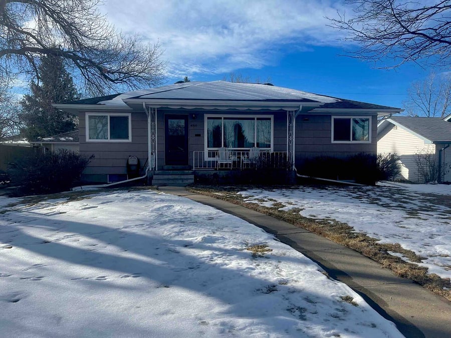 Looking at the front yard, porch and exterior of the Englewood home from the street out front. Theres plenty of room to park and the driveway can accommodate RV parking.