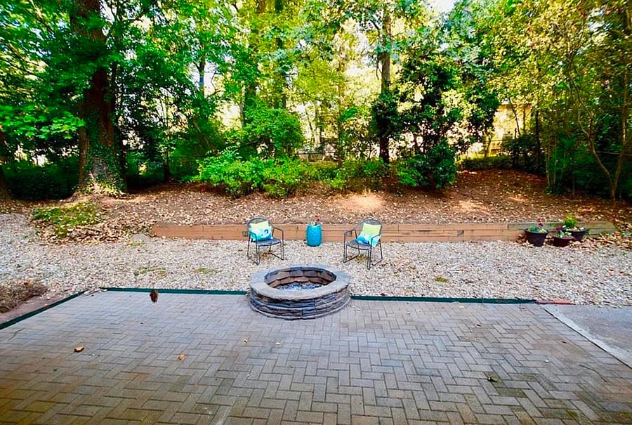 Fire pit in fenced backyard.
