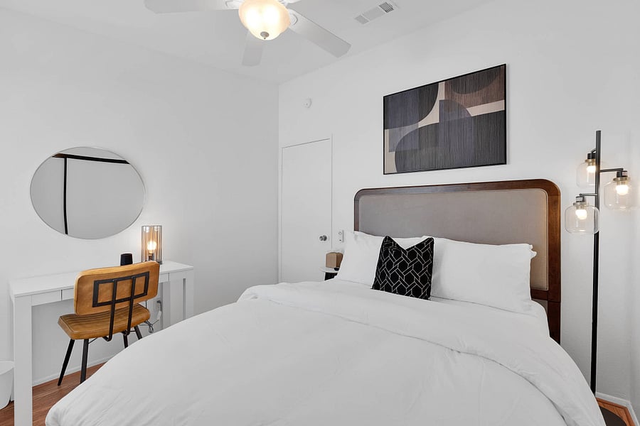 Bedroom 3 with queen bed, ceiling fan, window shutters, workspace, and smart TV
