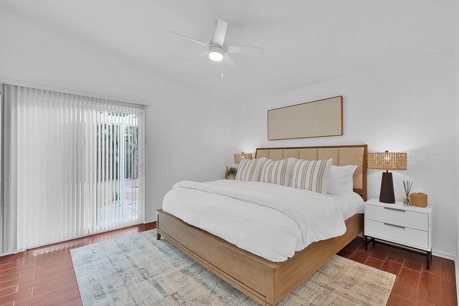 Primary bedroom with king bed, ceiling fan, smart TV, and ensuite bathroom