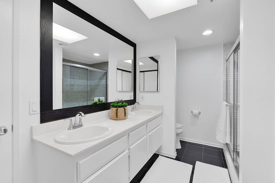 Primary ensuite bathroom with standing shower and hair dryer