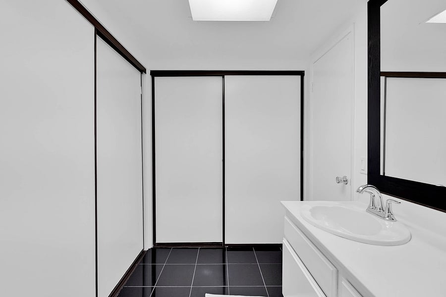 Primary ensuite bathroom with standing shower and hair dryer