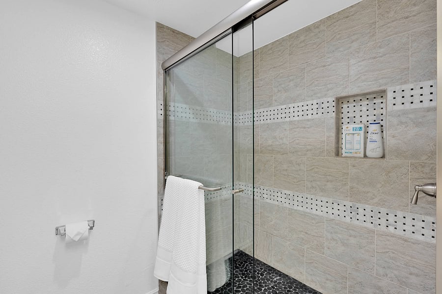 Primary ensuite bathroom with standing shower and hair dryer
