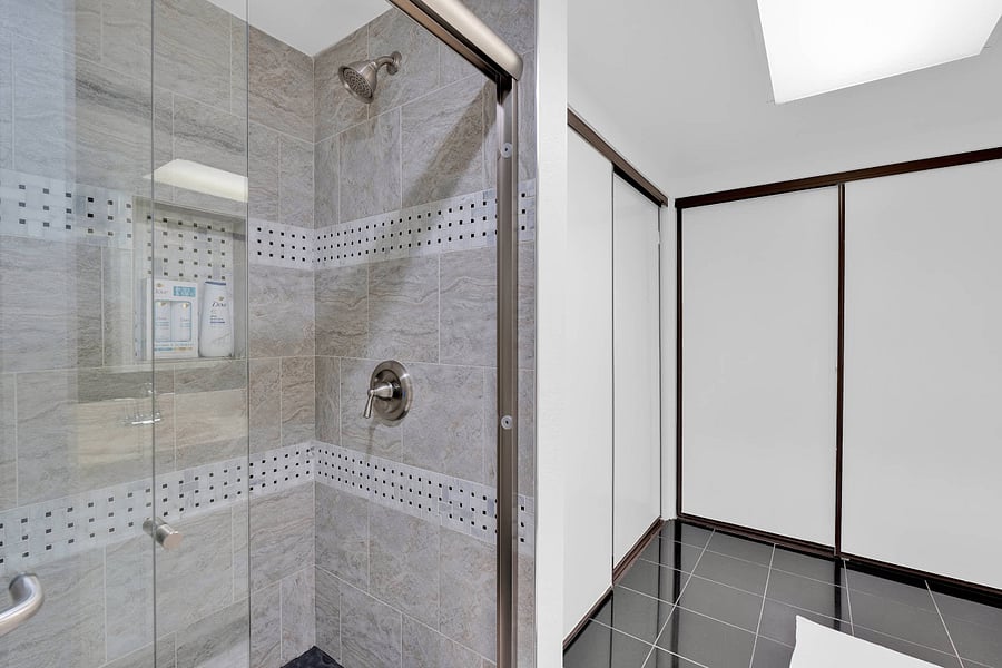 Primary ensuite bathroom with standing shower and hair dryer