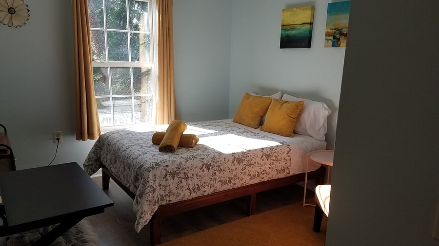 Plush full bed in the 2 bedroom suite facing front yard.