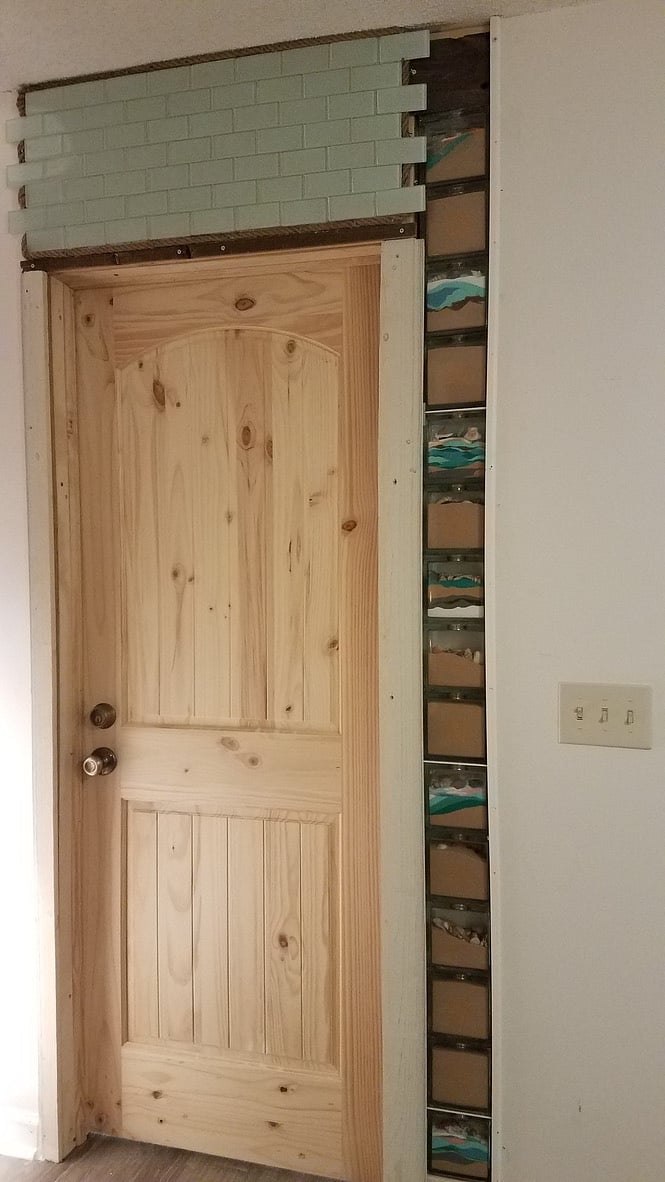 This is the solid core door on the outside (in living room) of the 2 bedroom/one bath suite. Has a beautiful homemade shell and sand wall!