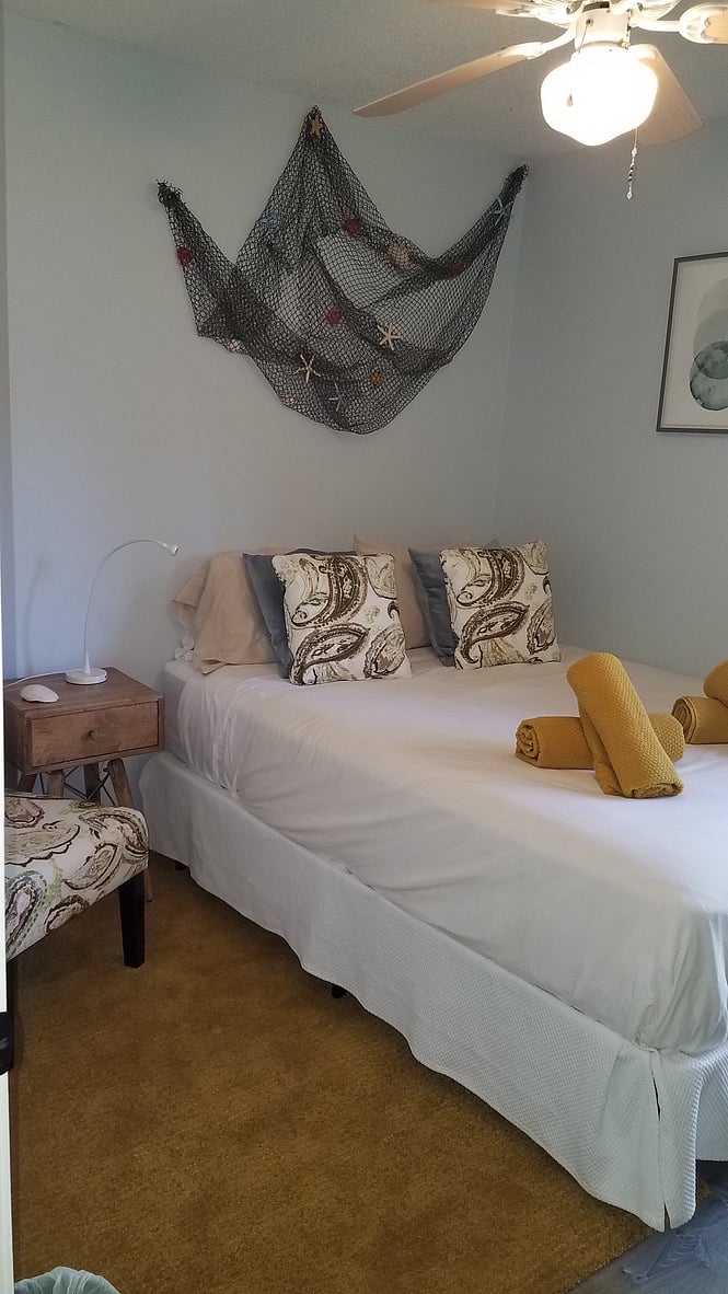 Firm queen bed facing the backyard in the 2 bedroom suite.