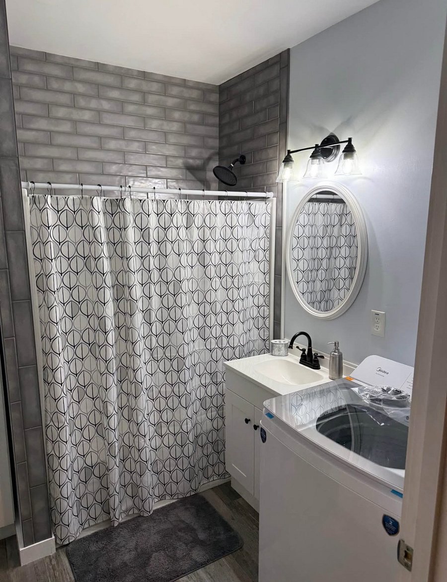 Bathroom with tub/shower combination, large storage closet, full size washer and dryer.