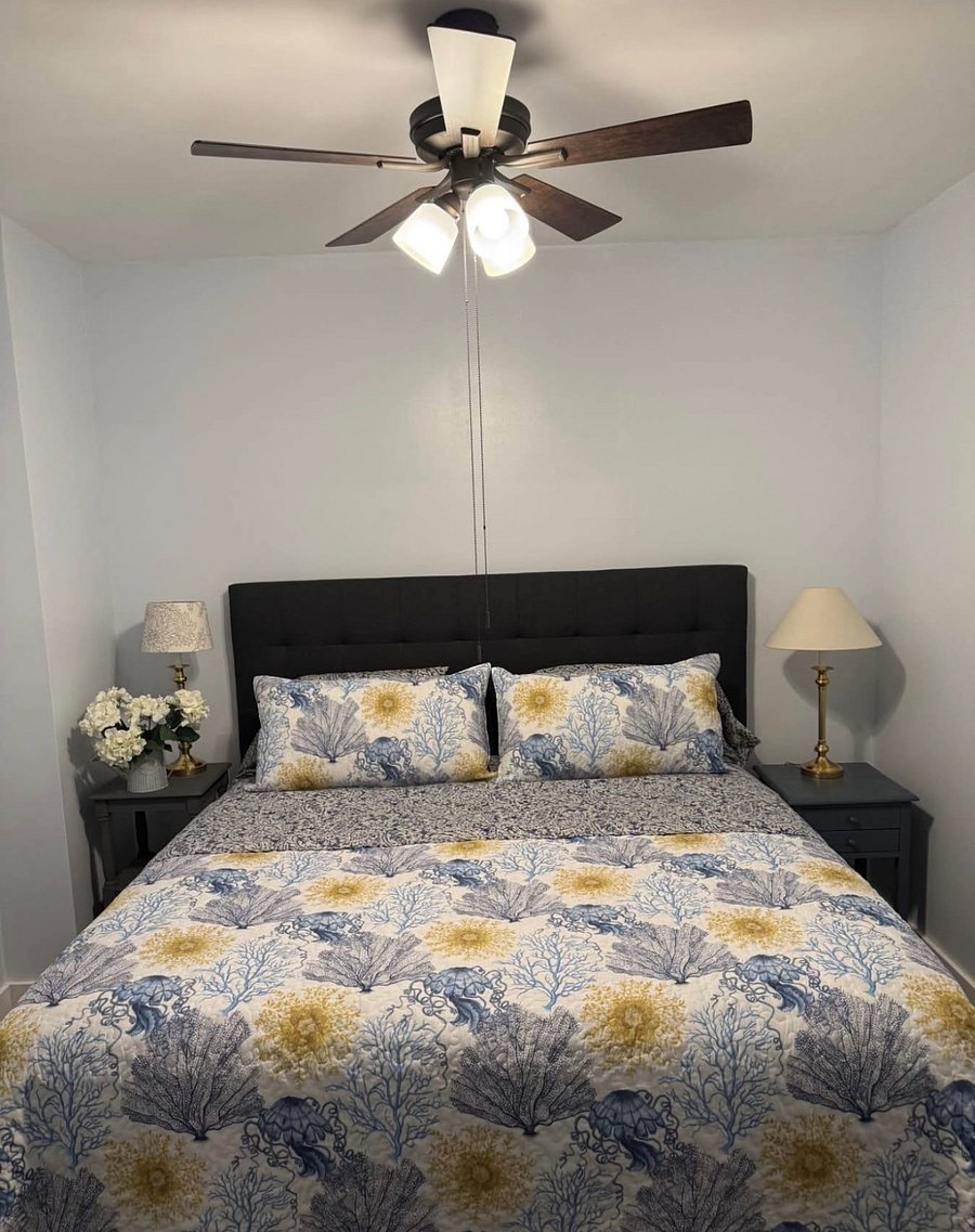 Beautiful bedroom with king size bed, 2 night stands, and large dresser.