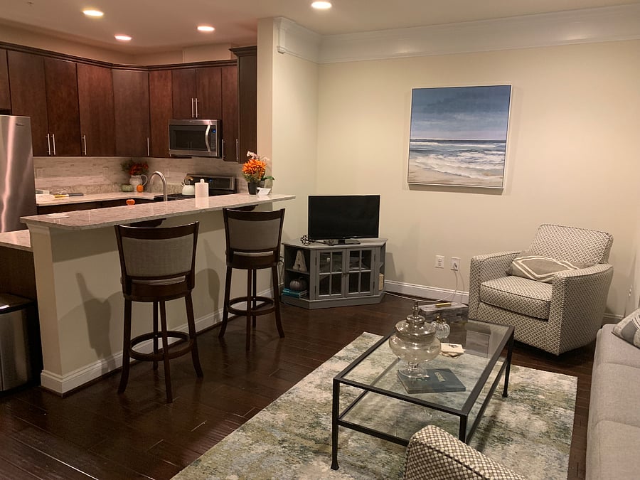 Kitchen is open to the dining room and second floor living room. TV has been updated from this picture to a larger smart tv. 