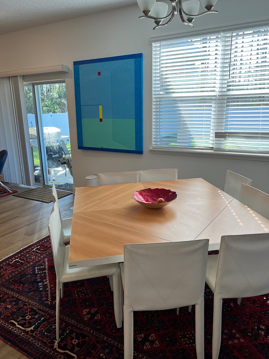 European designer dining table unfolds easily for 8 guests 