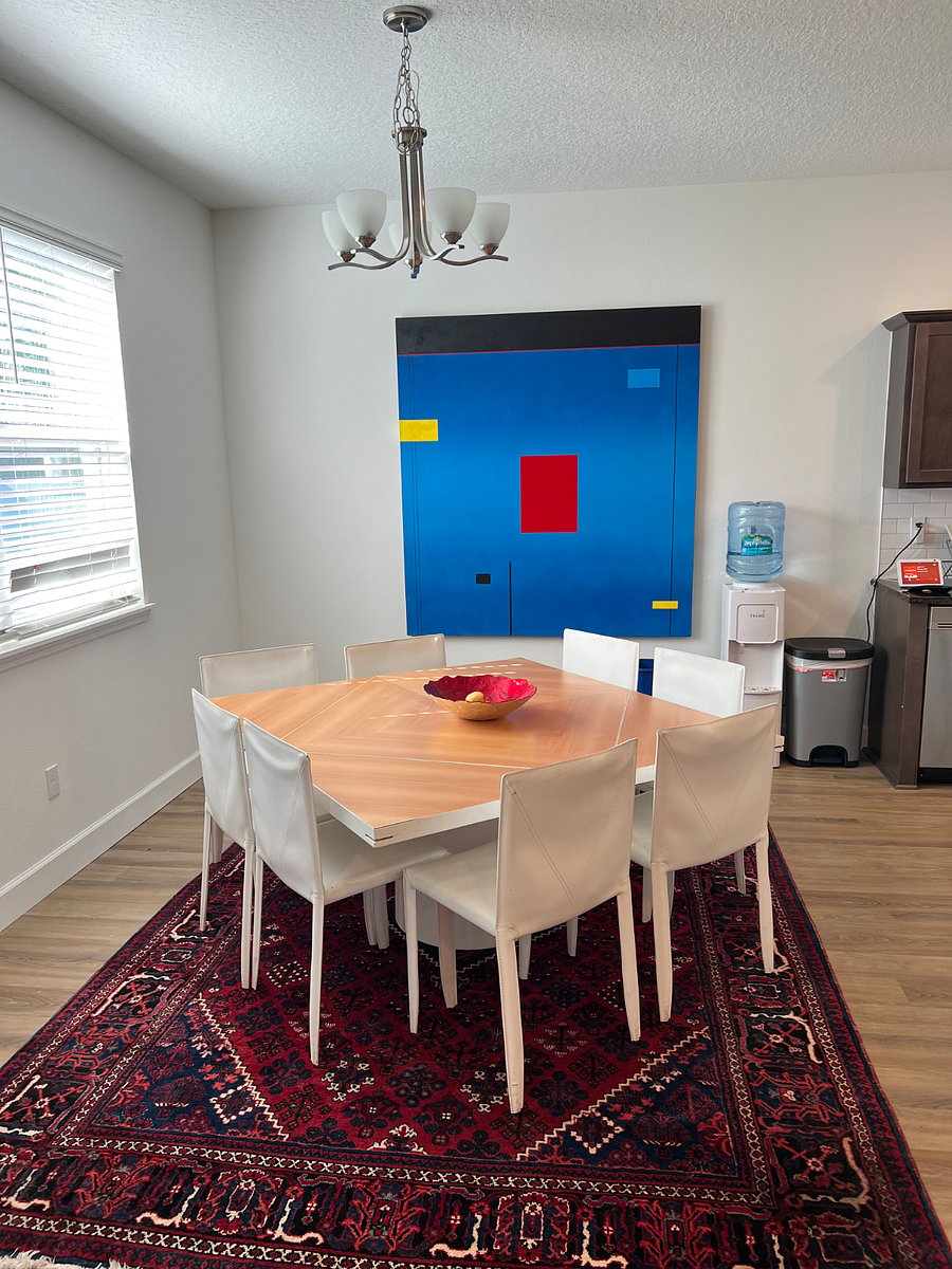 Designer dining room set and modern paintings across the house 