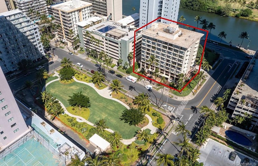 Open green area surrounding the building in front and back of building.